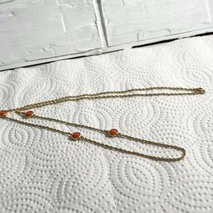 Gold necklace with orange accents